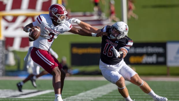 Aggie linebacker Gabe Peterson reaches for UMass quarterback Taisun Phommachanh during an Aggie football game on Saturday, August 256 2023, at the Aggie Memorial Stadium.